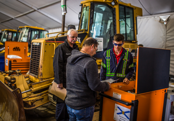 People in front of a tractor